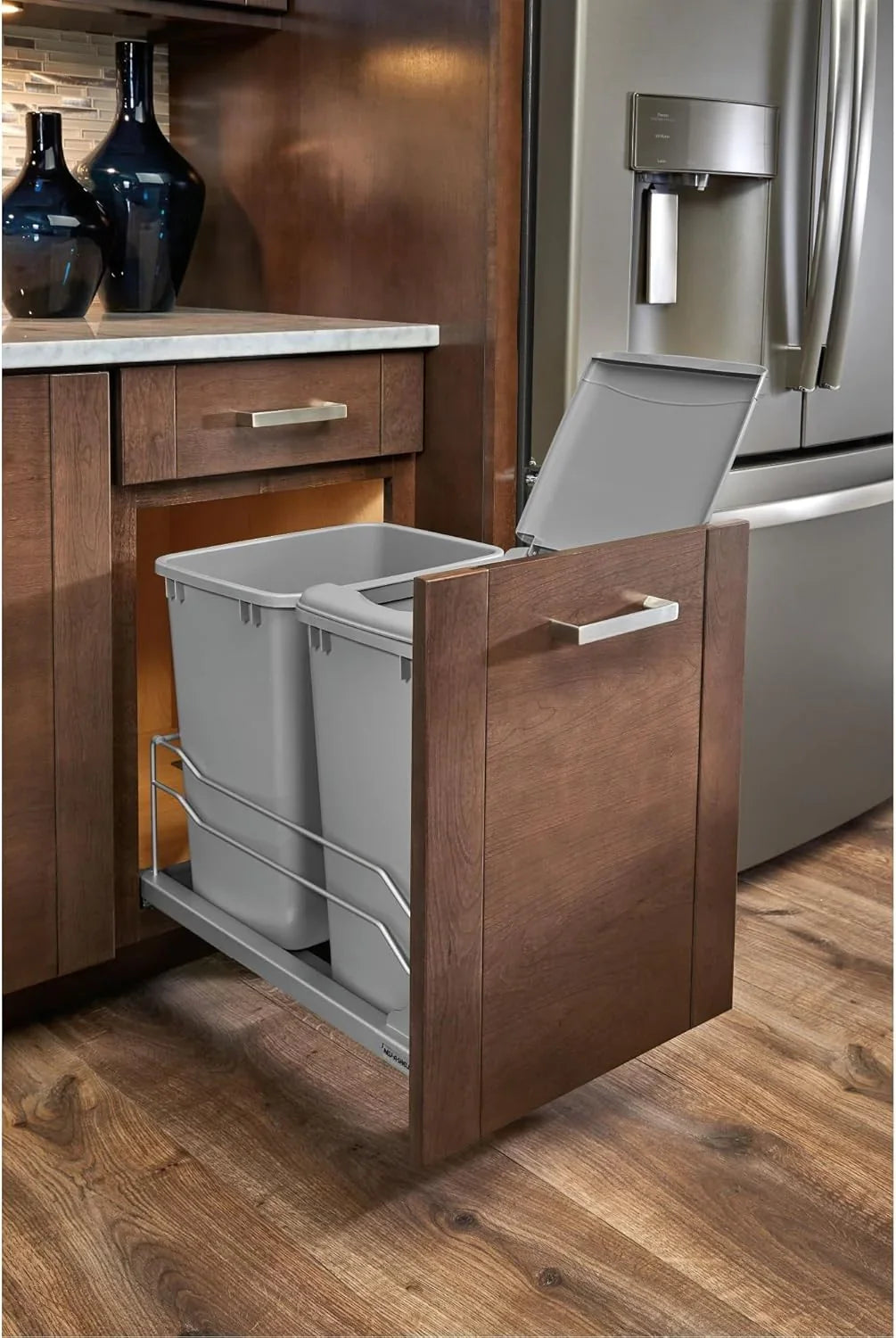 A double pull-out trash can suitable for the bottom of kitchen cabinets, with a capacity of 35 ounces (approximately 0.875 gallons), equipped with a gentle closing sliding mechanism, and in the color of Orison Gray.